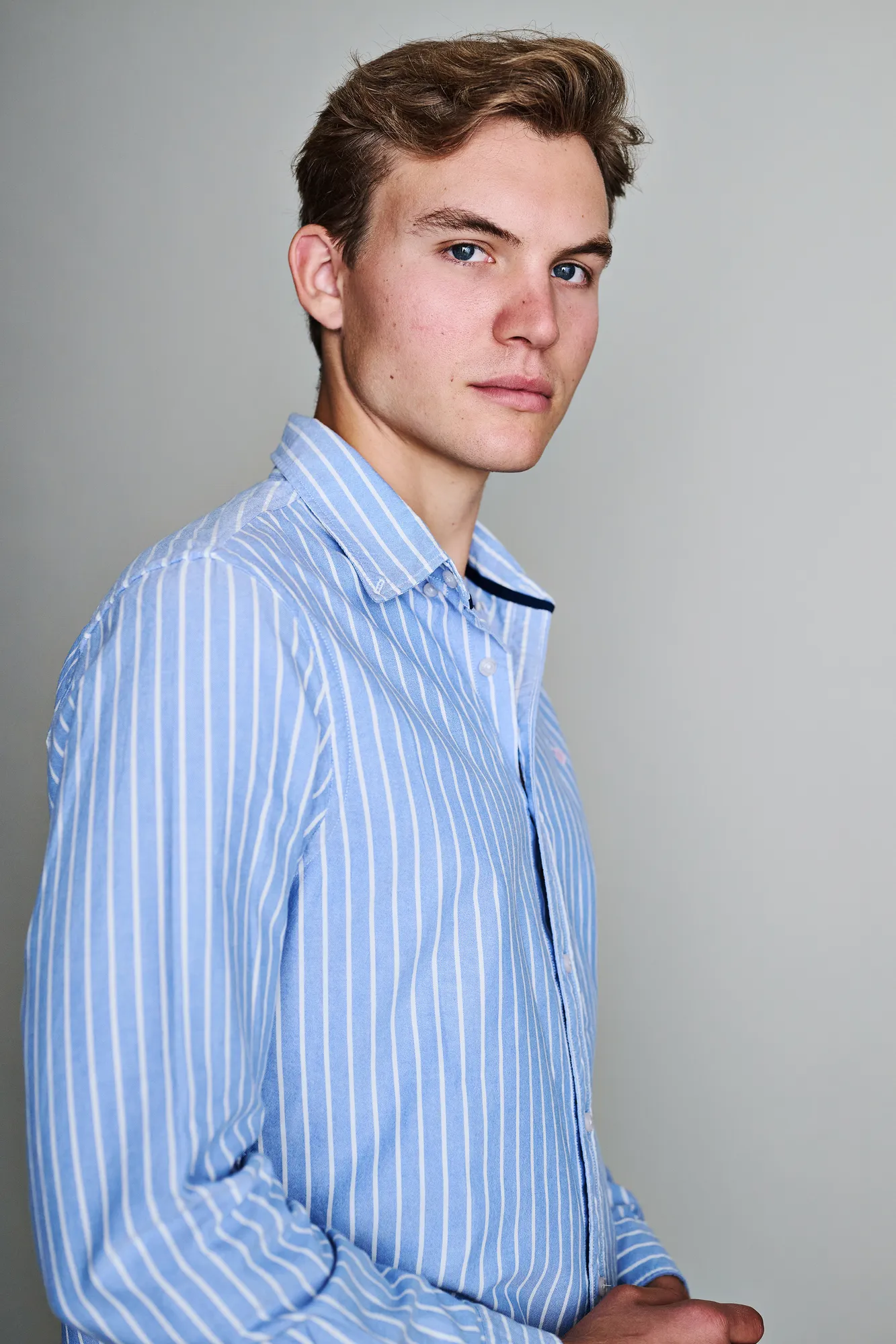 Ferdinand McKay actor headshot in blue striped shirt
